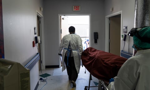 Medical staff push a stretcher with a deceased patient out of the Covid-19 intensive care unit at the United Memorial Medical Center on June 30, 2020 in Houston, Texas.