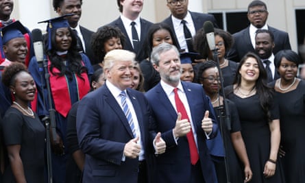 President Trump poses with Liberty University president Jerry Falwell Jr., center right, in front of a choir during commencement ceremonies at the school in Lynchburg, Va., Saturday, May 13, 2017.