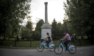 Cyclists using the bike-sharing program pass the Balbo Monument, a gift from Italian dictator Benito Mussolini to the city of Chicago in 1933.