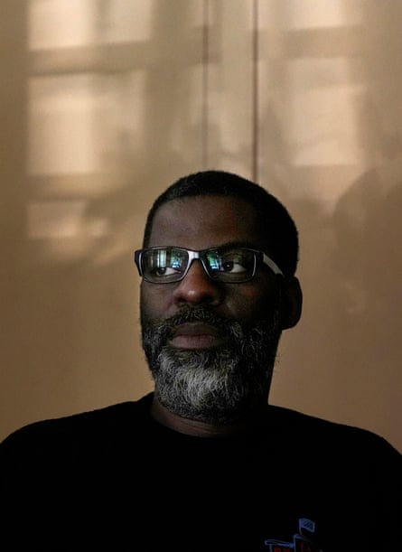 a man in glasses looks into the distance