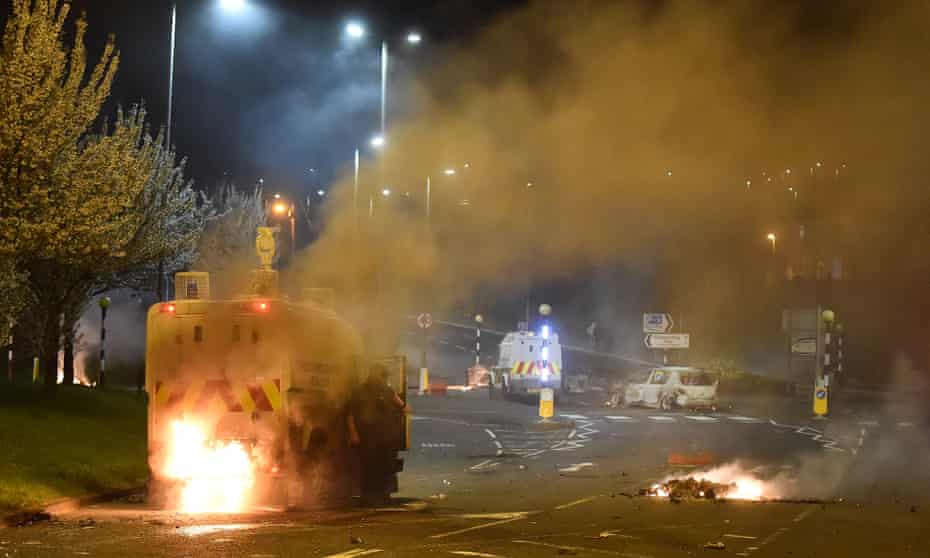 Police attend the scene at Cloughfern roundabout, Newtownabbey, as loyalist protesters hijack and burn vehicles on 4 April 2021