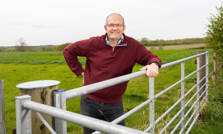 Tom Bradshaw smiling over farm gate
