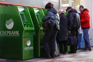 Russia-Ukraine war latest news: US condemns Putin’s nuclear deterrence order; rouble crashes as markets open – live updates | World news 2 People use Sberbank ATM machines at the Kazansky railway station.