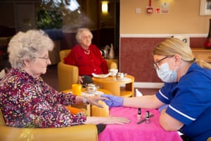 Social care assistant Audrey Halley runs a nail bar and manicure with resident Helen Ford at McClymont House