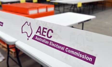 Boxes of senate ballot papers, ready for polling booths are seen behind white and purple tape at an Australian Electoral Commission warehouse 