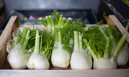 A wooden box containing fennel at a fruit and veg distributor.