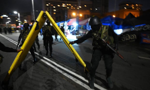 Soldiers remove protesters' barricades blocking the presidential office entrance