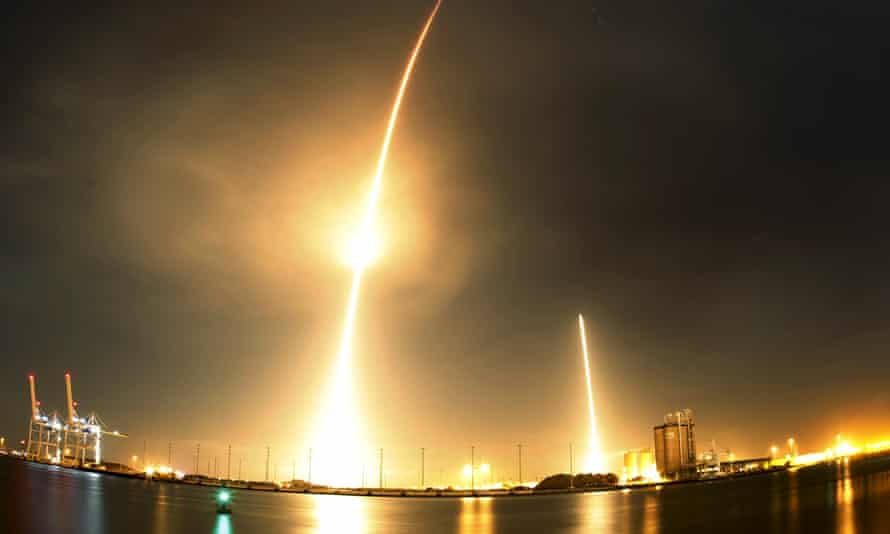 A long exposure photograph shows the SpaceX Falcon 9 lifting off from its launchpad (left) and then returning to a landing zone at Cape Canaveral.