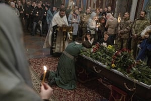 Yevheniya reacts next to the coffin of her husband, Ukrainian serviceman Yevhen Kolesnichenko, during his funeral ceremony in St Michael’s monastery in Kyiv