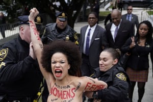 A protester is subdued by the police after breaking through the barriers, as actor and comedian Bill Cosby arrived for the first day of his sexual assault retrial at the Montgomery county courthouse.