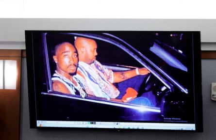 A 1996 photo of rapper Tupac Shakur (L) and Marion “Suge” Knight is displayed on a television in a courtroom