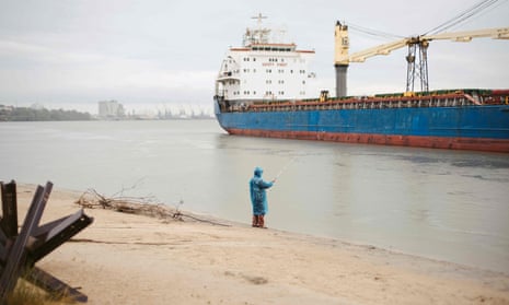 A fisherman fishes on the banks of the Danube River, near the port of Izmail, southwestern Ukraine, in July 2023.