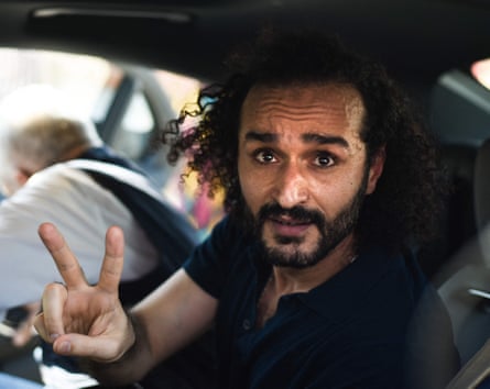 Ahmed Douma in car making peace sign