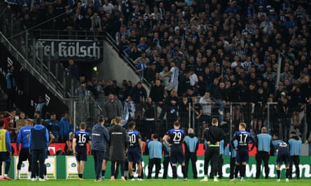 Hertha’s players and staff go over to apologise to the fans