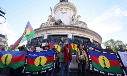 Demonstrators hold Kanak and Socialist National Liberation Front (FLNKS) flags during a gathering in Paris, Thursday 16 May 2024.