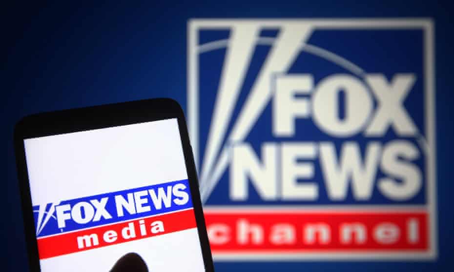 The Fox News logo is seen on a smartphone and computer screen.