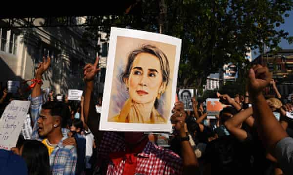 Aung San Suu Kyi’s picture held by protesters