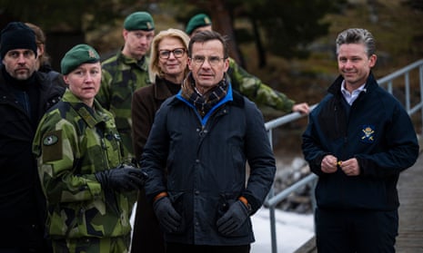 Swedish prime minister Ulf Kristersson watches a military demonstration on 20 February 2024 at Berga naval base.