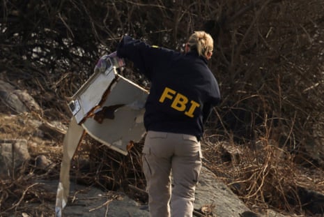 a person with jacket that says 'fbi' with debris a person with jacket that says 'fbi' with debris