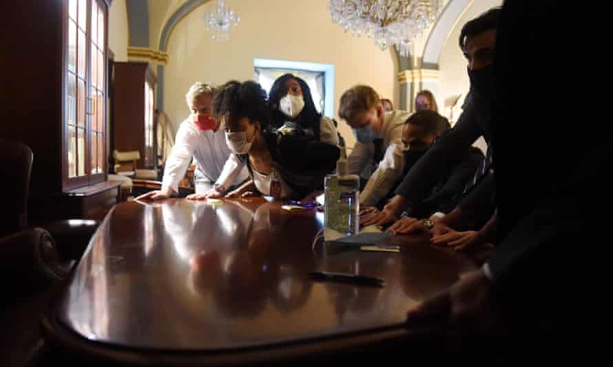 Congress staffers create a barricade inside the US Capitol, 6 January.