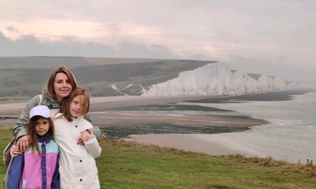 Svitlana Tselishcheva and her daughters stand with the white cliffs of Dover in the background.
