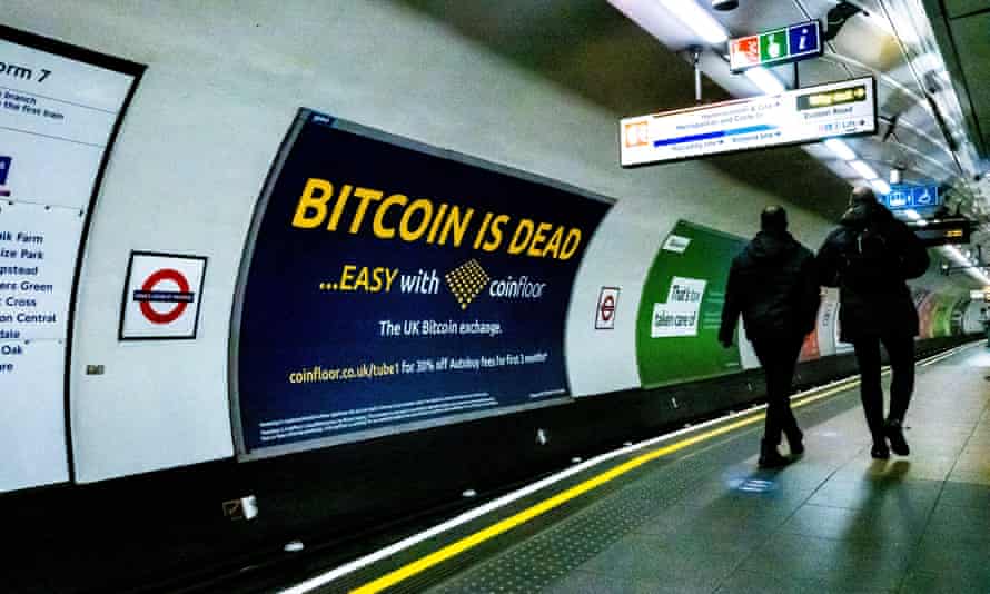 A cryptocurrency advertising poster in a London Underground station.