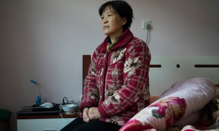 Zheng Ruixia on her daughter’s bed where she spends most of her days, at her home in Jiyuan, China.