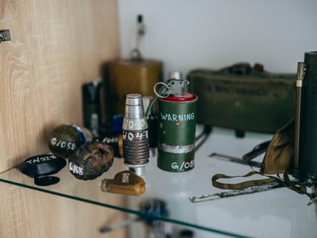 Different types of ammunition on a glass shelf.