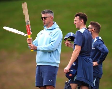England specialist mentor Kevin Pietersen holds a broken bat as Harry Brook and Brendon McCullum look on