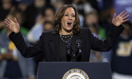 a woman gesticulates at a podium