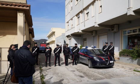 Carabinieri police stand guard near Denaro’s apartment in the Sicilian town of Campobello di Mazara