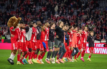 Bayern Munich players and mascot line up to celebrate victory over Bayer Leverkusen.