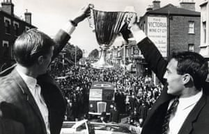 Tottenham’s Peter Baker and Greaves (right) show off the European Cup Winners’ Cup to their fans on their victory parade through north London after they beat Atlético Madrid 5-1, with Greaves scoring twice