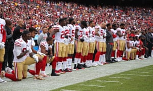 San Francisco 49ers players take a knee during the national anthem prior to their game against Washington