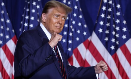 Donald Trump raises his fists in celebration.