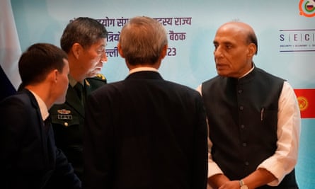 Rajnath Singh, right, talking with Li Shangfu, second left, at the SCO summit in New Delhi.