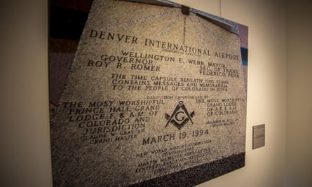 A photo of the dedication stone at Denver International Airport, featured in an exhibition about conspiracy theories related to the airport