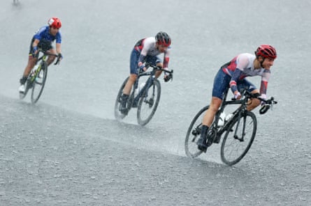 Sarah Storey (right) battling through torrential rain on her way to victory.
