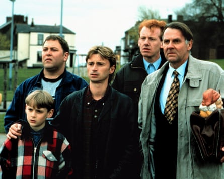 William Snape, Mark Addy, Robert Carlye, Steve Husion and Tom Wilkinson stand on a pavement in a scene from The Full Monty