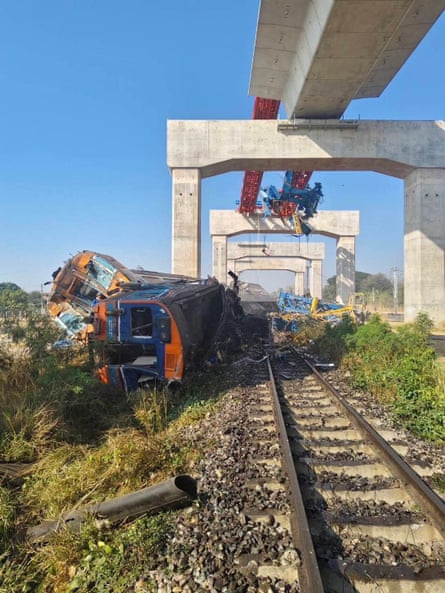 A train travelling from Bangkok to Ubon Ratchathani lies damaged after being derailed.
