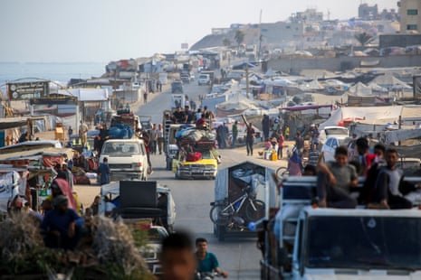 People and belongings crammed into moving vehicles.