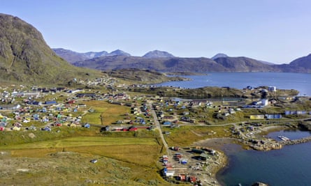 aerial view of town by water and mountains
