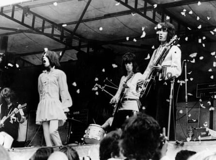 Mick Jagger, Keith Richards and Bill Wyman on stage, surrounded by white butterflies