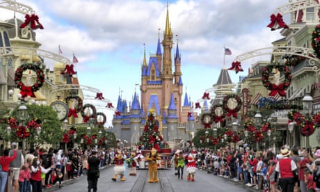 Crowds watch characters parade at Magic Kingdom in Lake Buena Vista, Florida.