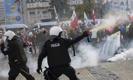 Riot police fire tear gas canisters toward protesters during a demonstration in Warsaw on Saturday.