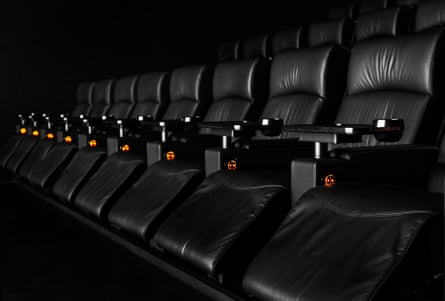 a row of black leather reclining cinema seats