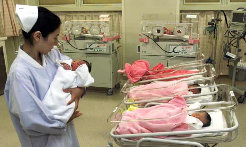 A nurse tends to a newborn child at a hospital in Tokyo