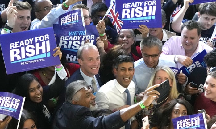 Rishi Sunak poses with supporters at Wembley Arena in London.