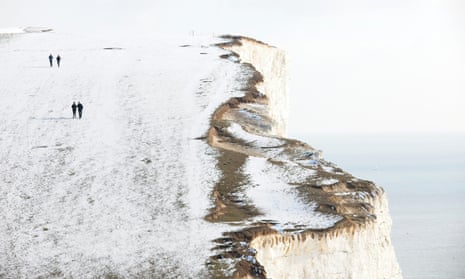 Walkers on a snow-covered Beachy Head near Eastbourne