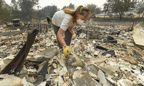 Sarah Hawkins, of Vacaville, finds a vase in the rubble after her home was destroyed by a fire in Vacaville on Thursday.